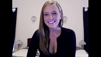 white american girl smiles and shows cleavage at home